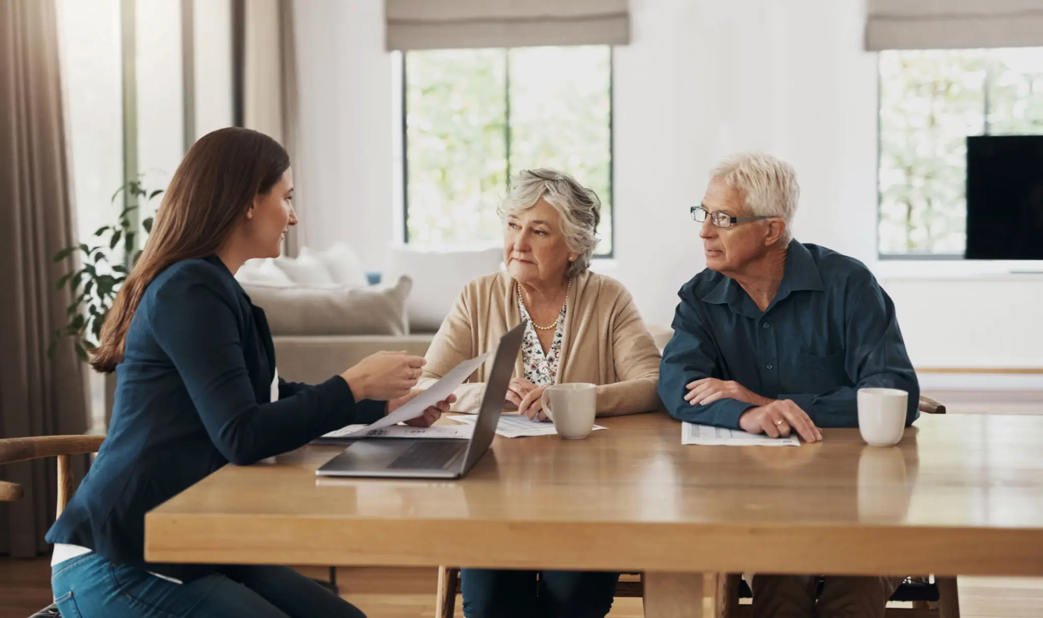 A couple consulting with a financial advisor at home.