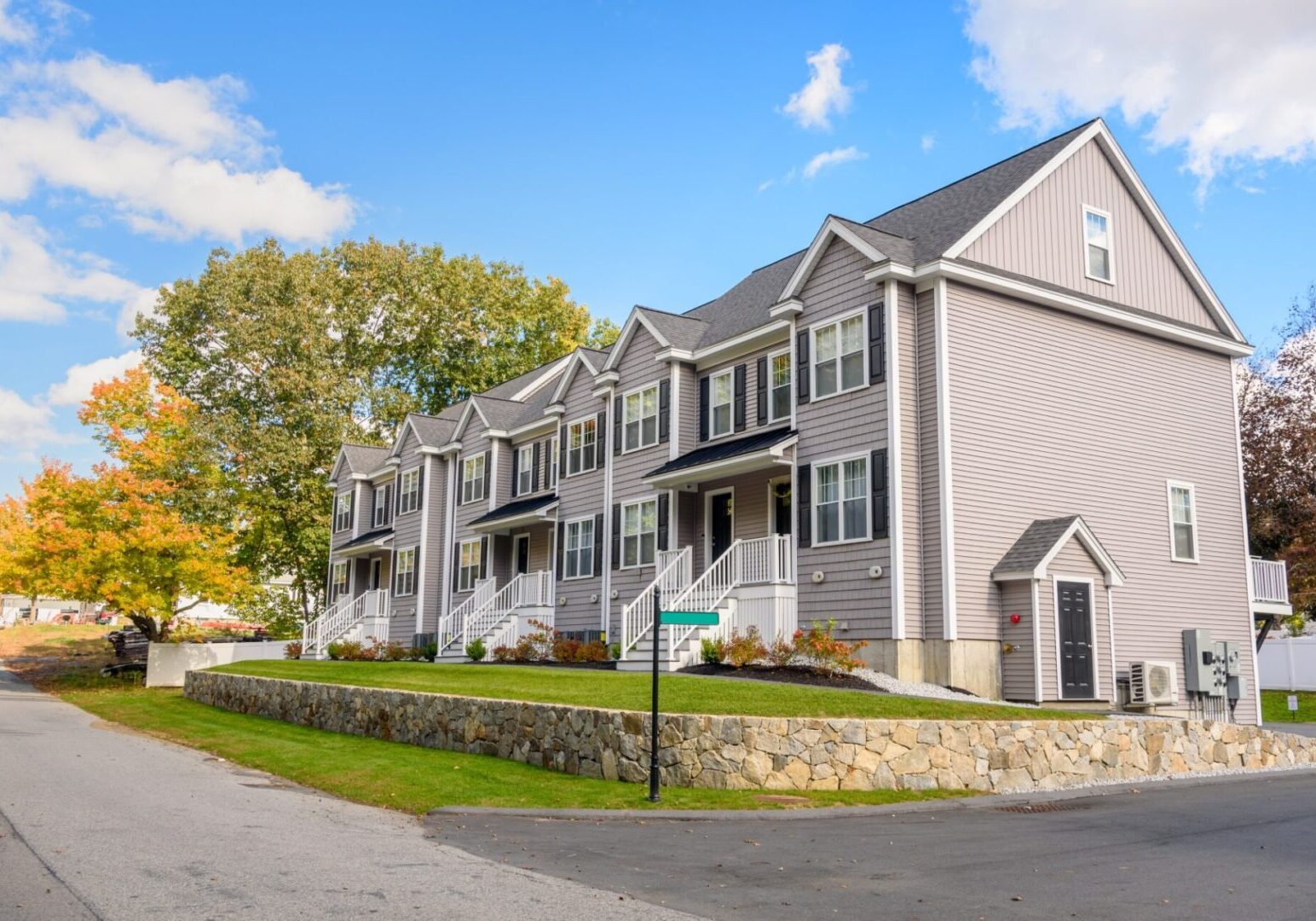 Modern townhouses with autumn trees