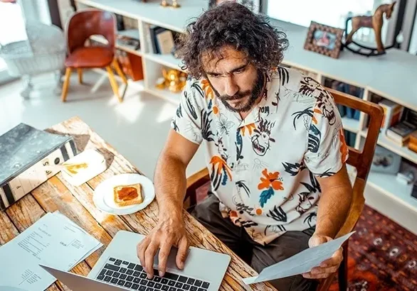 Man working on laptop at home office