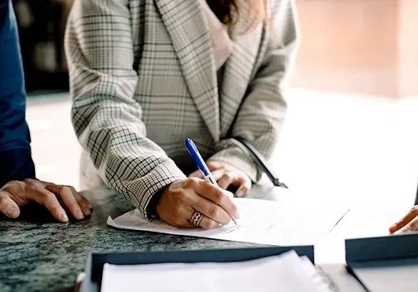 Close-up of hand writing on paper